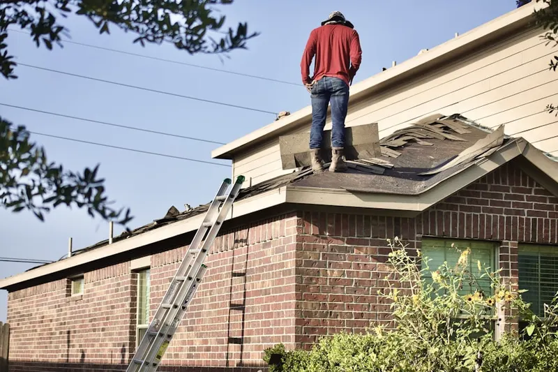 Professional roofer working on a residential roof in Denio